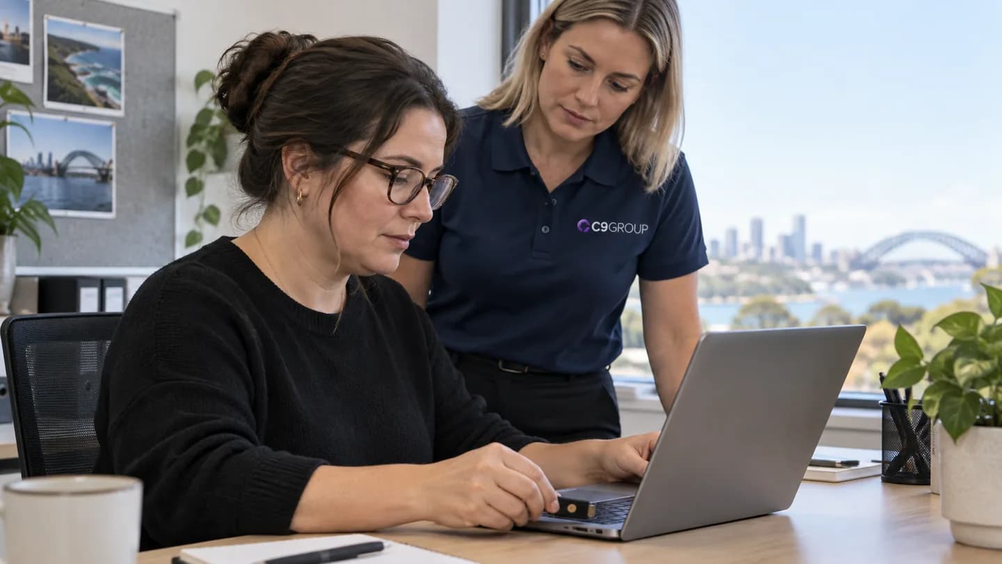 Office administrator using a security key with guidance from a C9 GROUP consultant