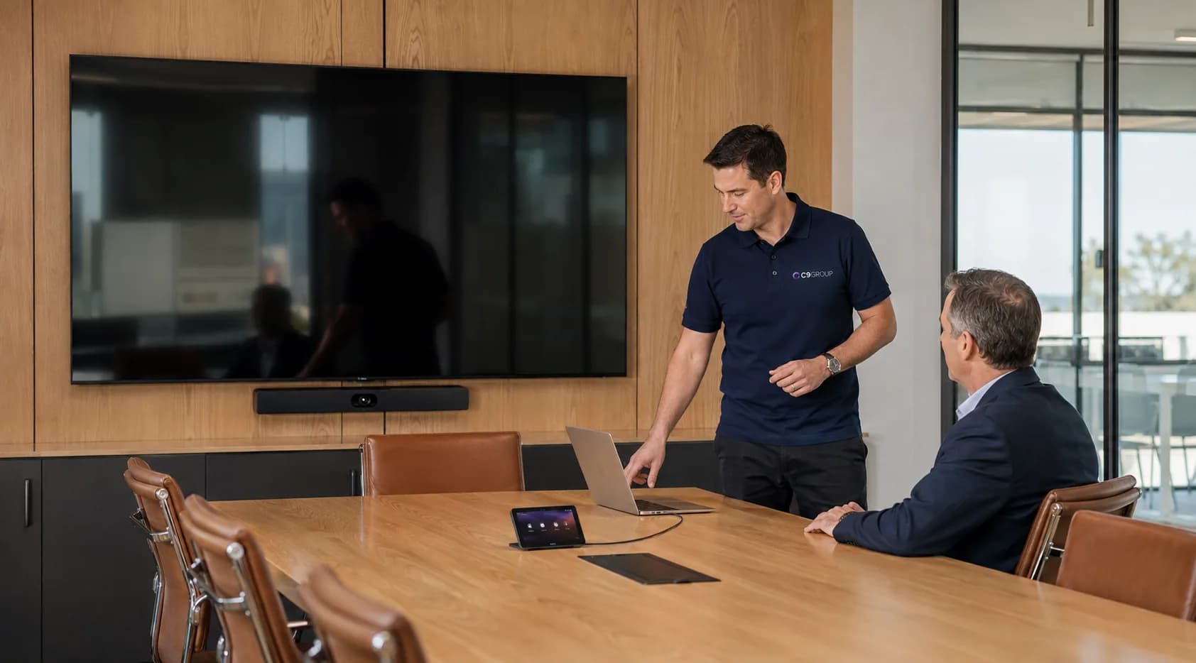 C9 GROUP staff member setting up a managed boardroom workplace environment