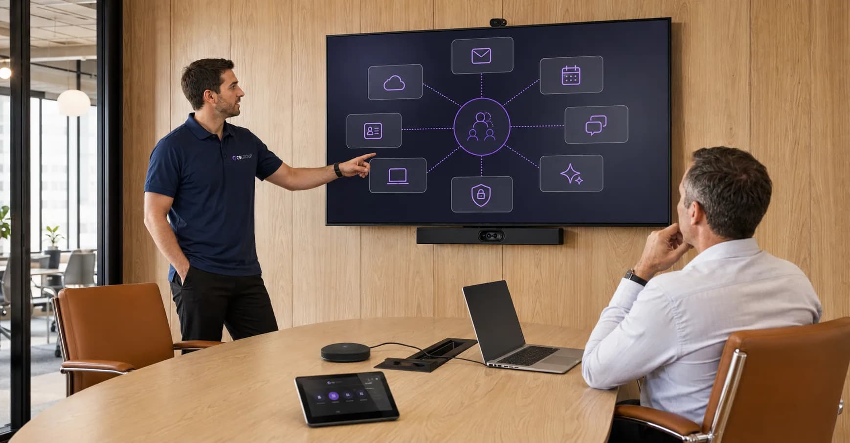 C9 GROUP staff member explaining a managed Microsoft 365 workplace ecosystem in an Australian boardroom