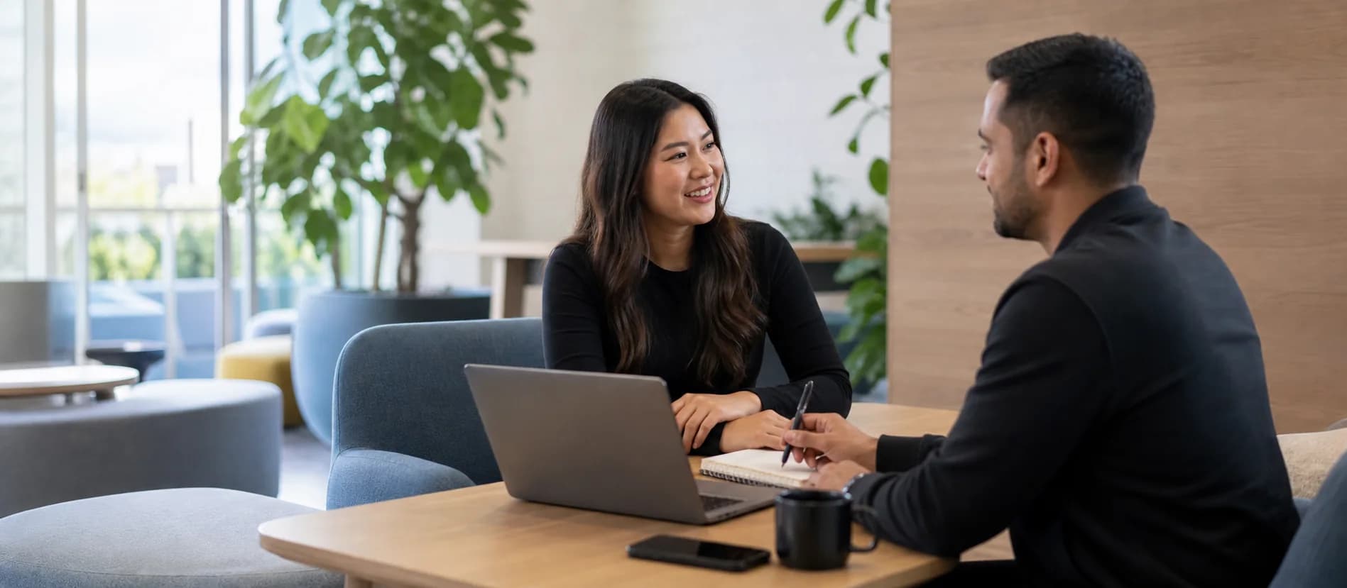 Remote professional discussing career goals in a modern office lounge